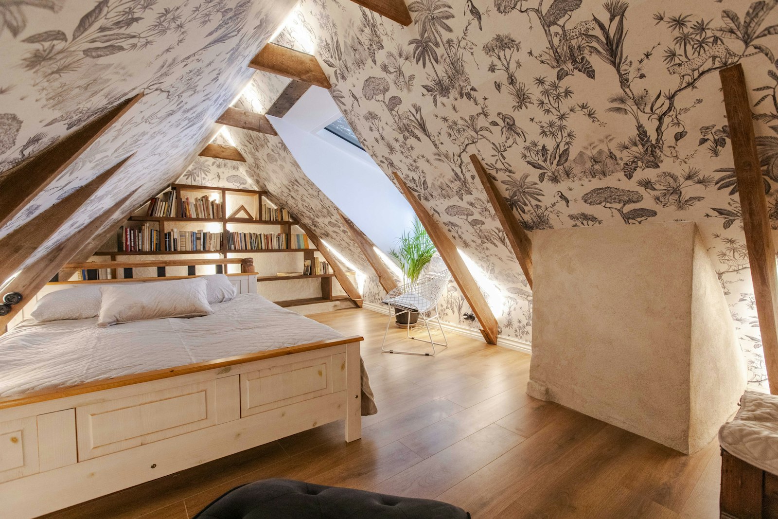 Bed and bookshelf at the gable end